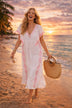 white v neck midi beach dress with pink embroidery to wear in the Caribbean