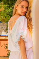 White low back beach dress to wear  in the Maldives by Lindsey Brown resort wear 